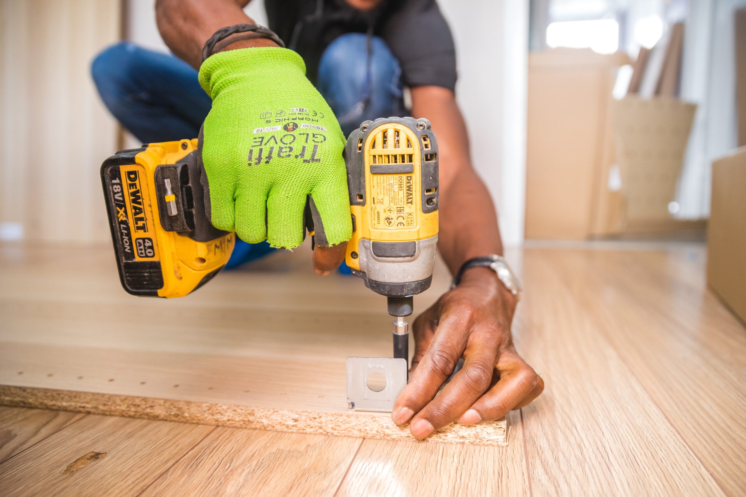 image of a man installing wooden flooring