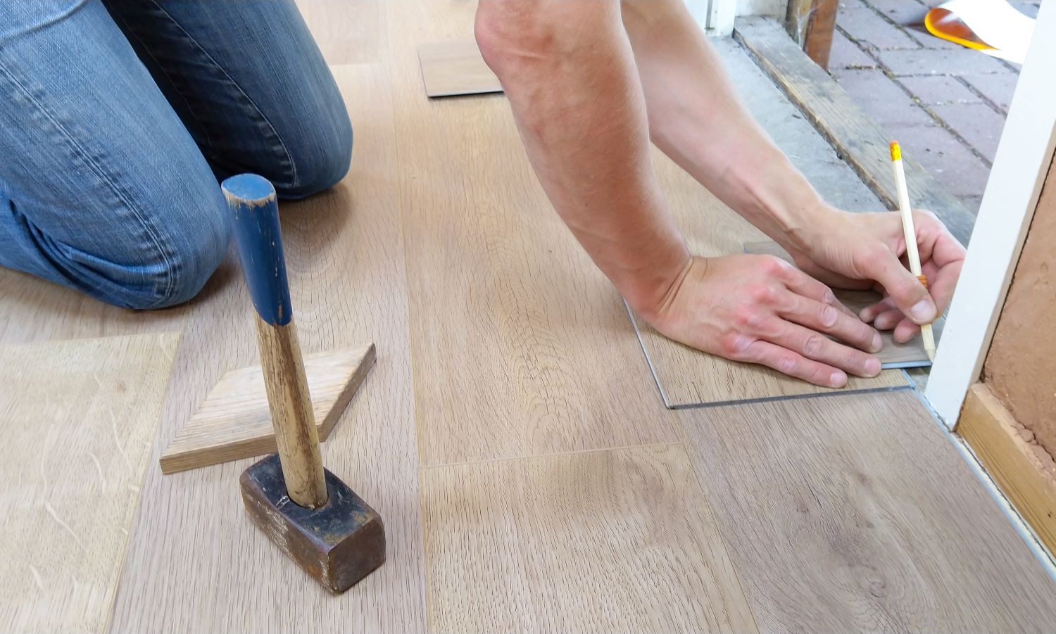 image of a man installing wooden flooring