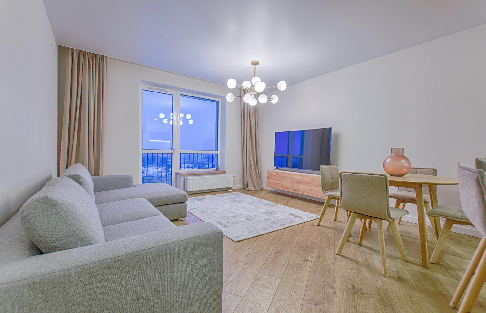an image of a grey fabric sectional sofa on brown wooden floor